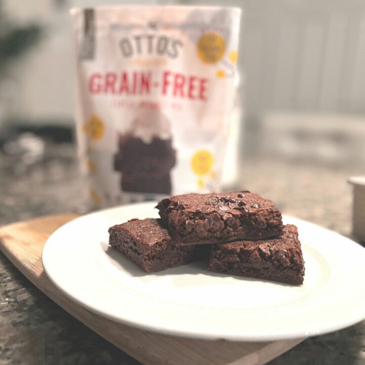 Brownies sitting on a plate in a kitchen