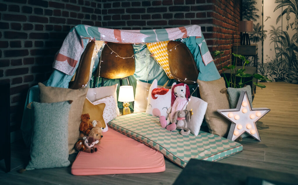 Diy tent decorated and prepared for pajama party to keep your toddler busy at home.